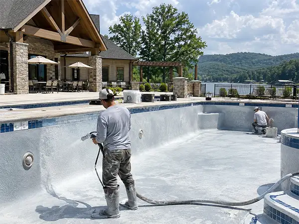 Pool technicians working on an empty swimming pool renovation project in Middle Tennessee